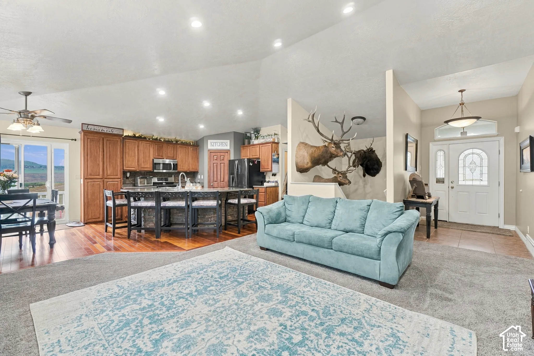 Vaulted ceilings, recessed lighting, and wood-finish flooring provide a bright and open atmosphere