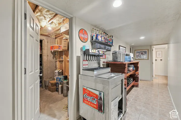 Tiled flooring, recessed lighting, and a paneled door