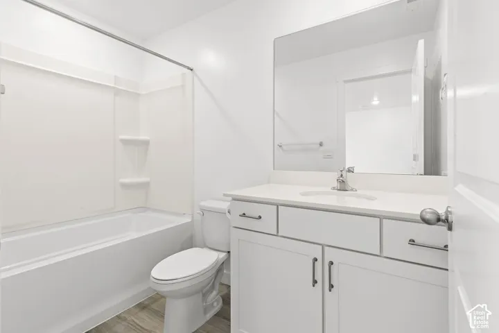 White vanity with a solid surface countertop and undermount sink