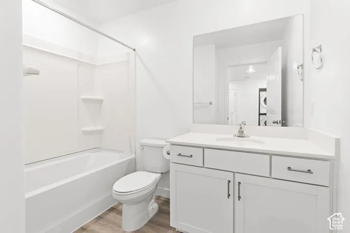 White vanity with an integrated sink, polished chrome faucet, and rectangular mirror