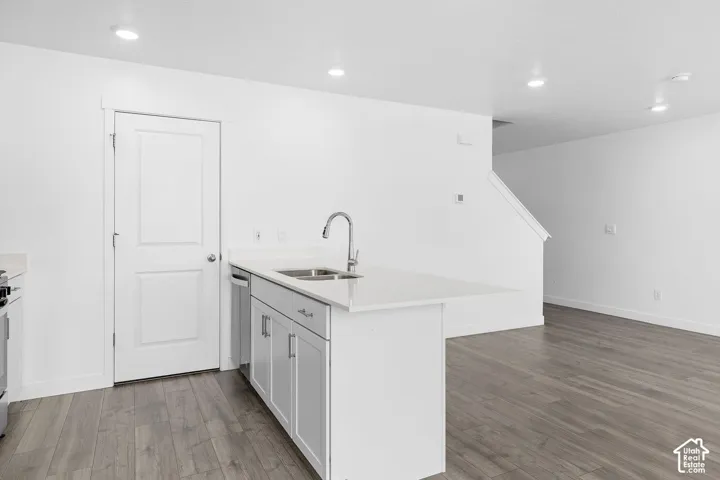 Kitchen island with an undermount double-basin sink and a gooseneck faucet