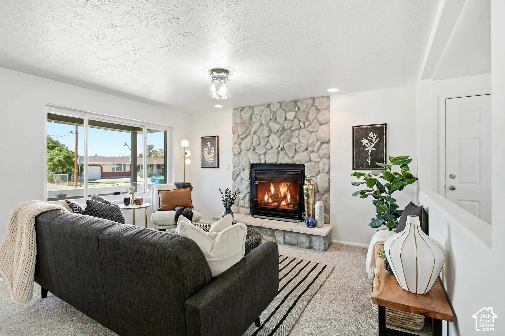Stone-faced fireplace with a black firebox and hearth