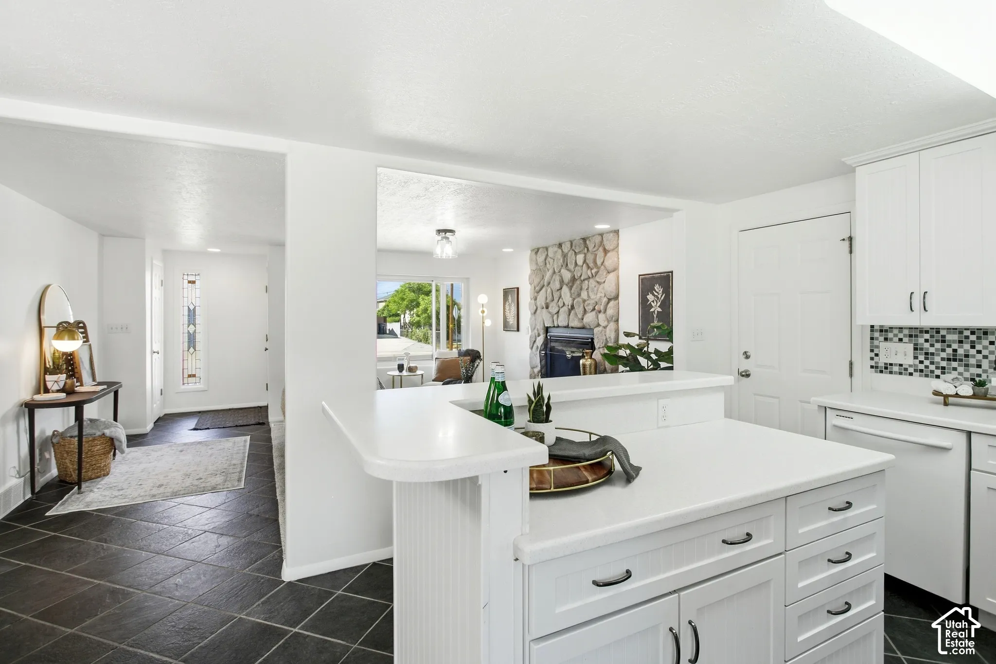 Kitchen island with white cabinetry and integrated breakfast bar