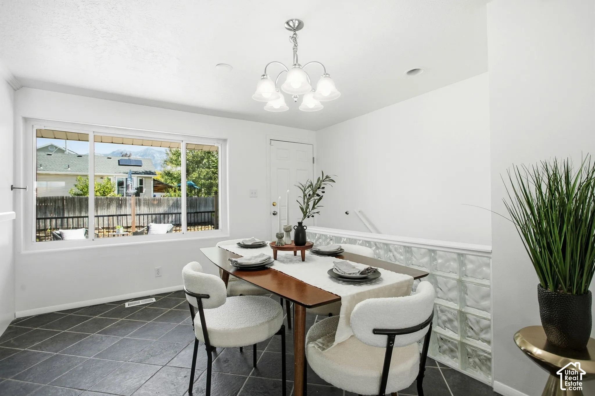 Recessed lighting, tiled flooring, glass block wall, overhead lighting fixture, and a window with a mountain backdrop