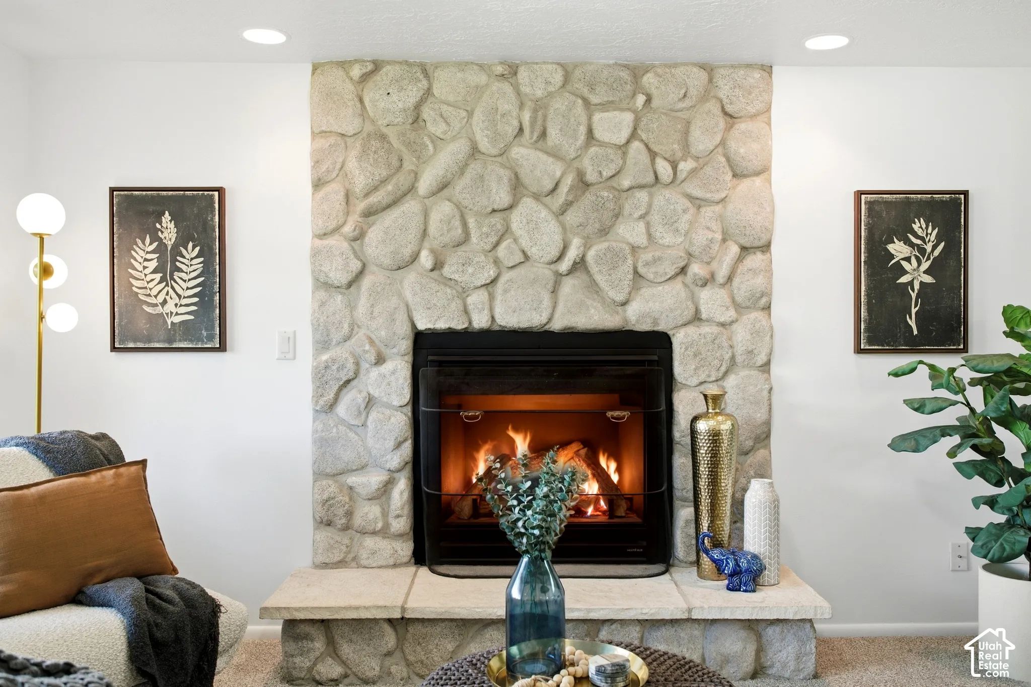 Stone-clad fireplace with a hearth and firebox insert