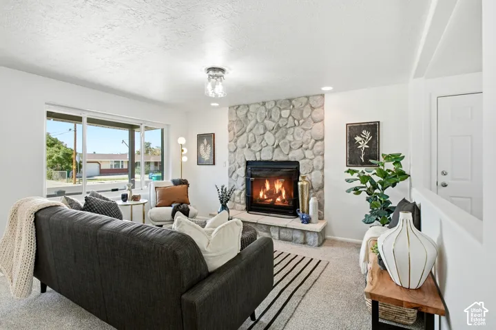 Stone-faced fireplace with a black firebox and hearth