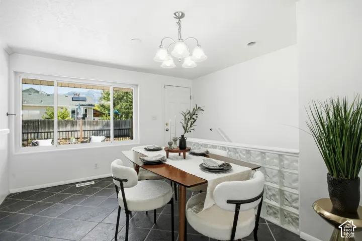 Recessed lighting, tiled flooring, glass block wall, overhead lighting fixture, and a window with a mountain backdrop