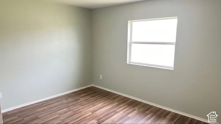 Wood-finish flooring, light-toned wall paint, and a white-framed window