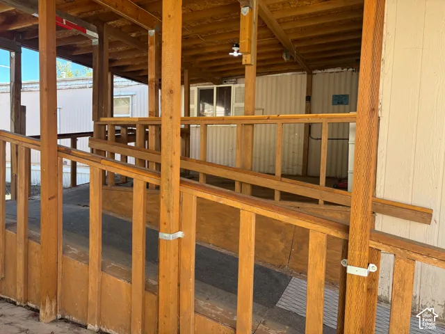 Covered porch entry featuring a wood-framed ramp and railings