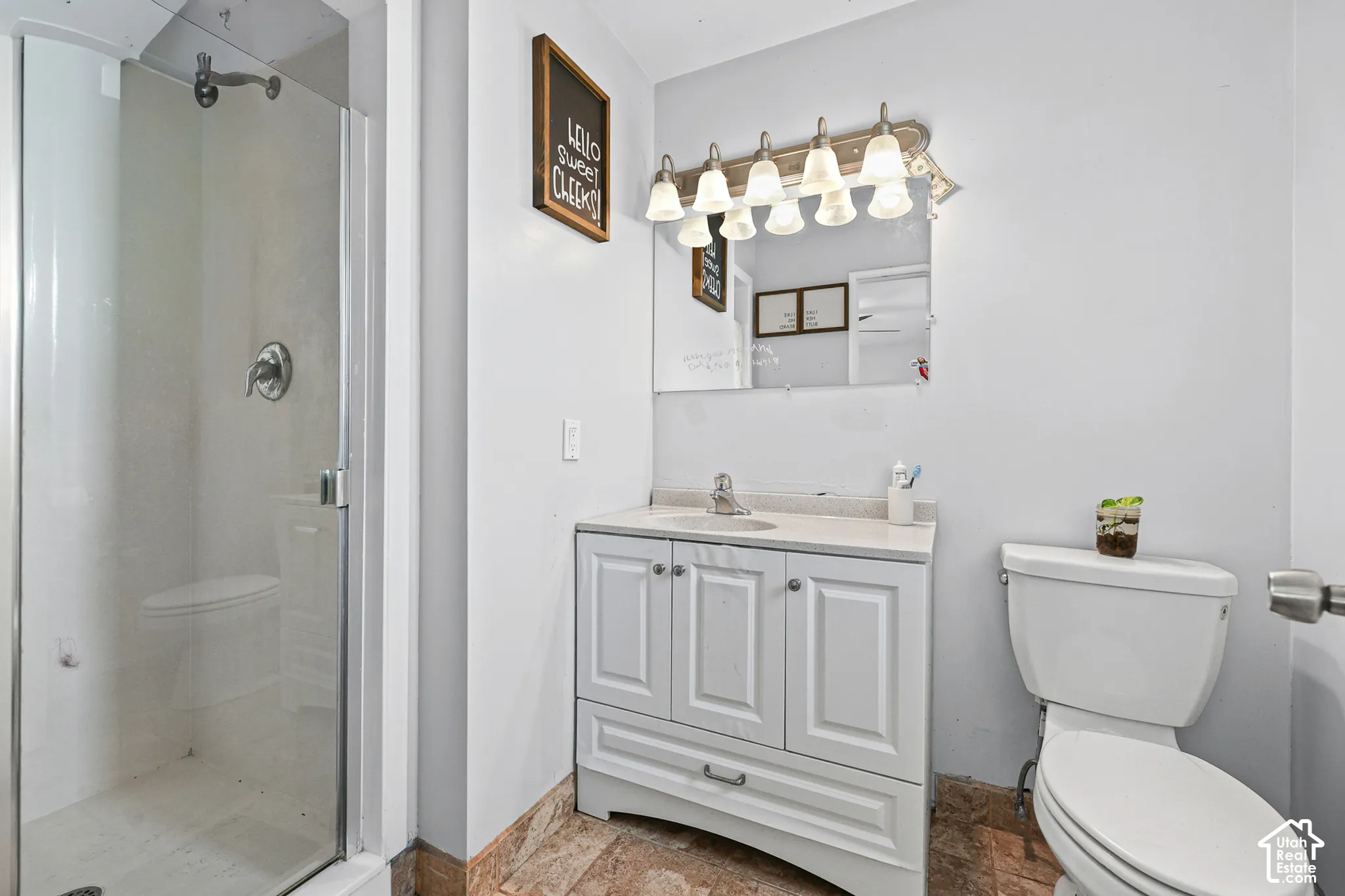 Glass-enclosed shower with chrome fixtures