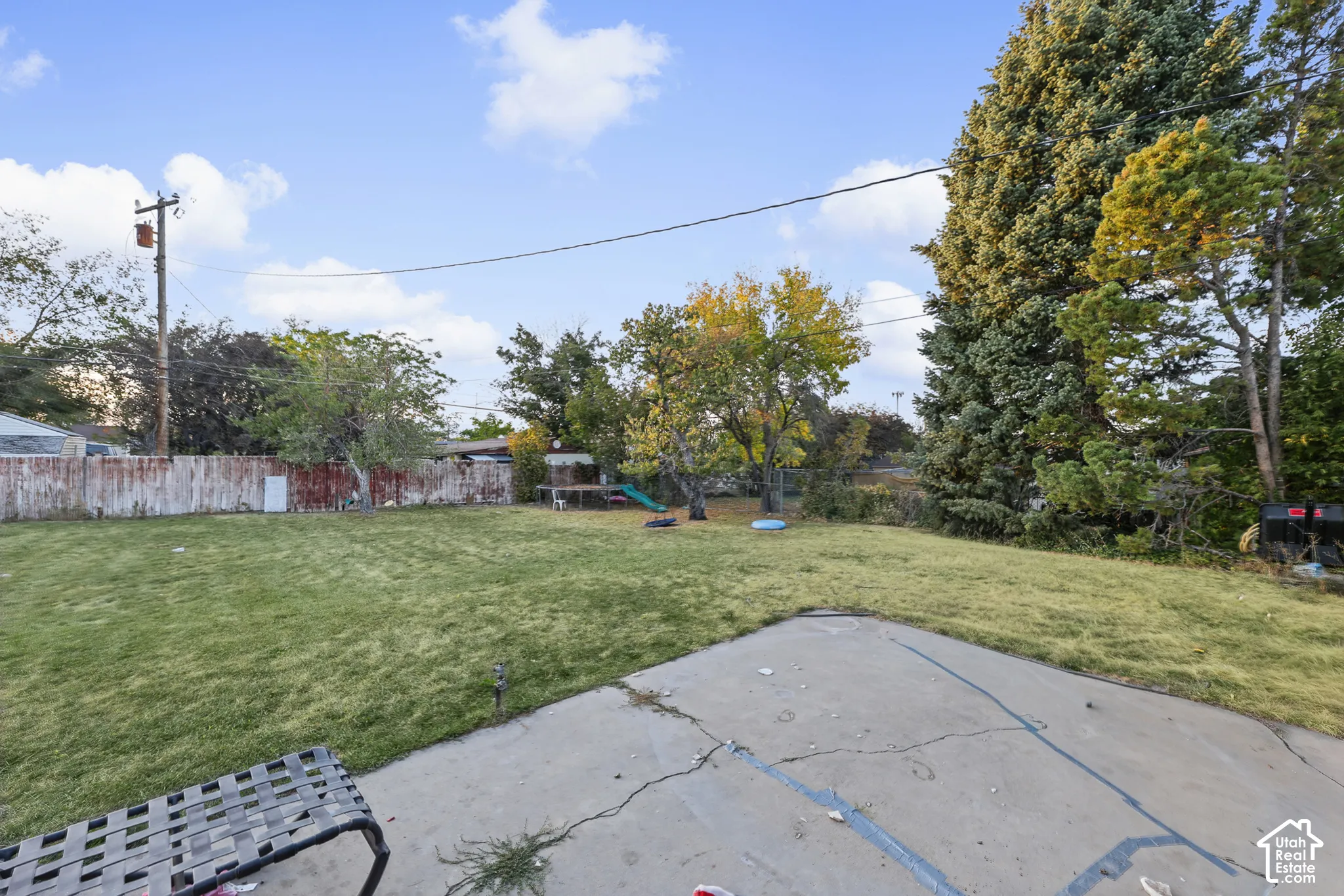 Expansive grassy yard with mature trees
