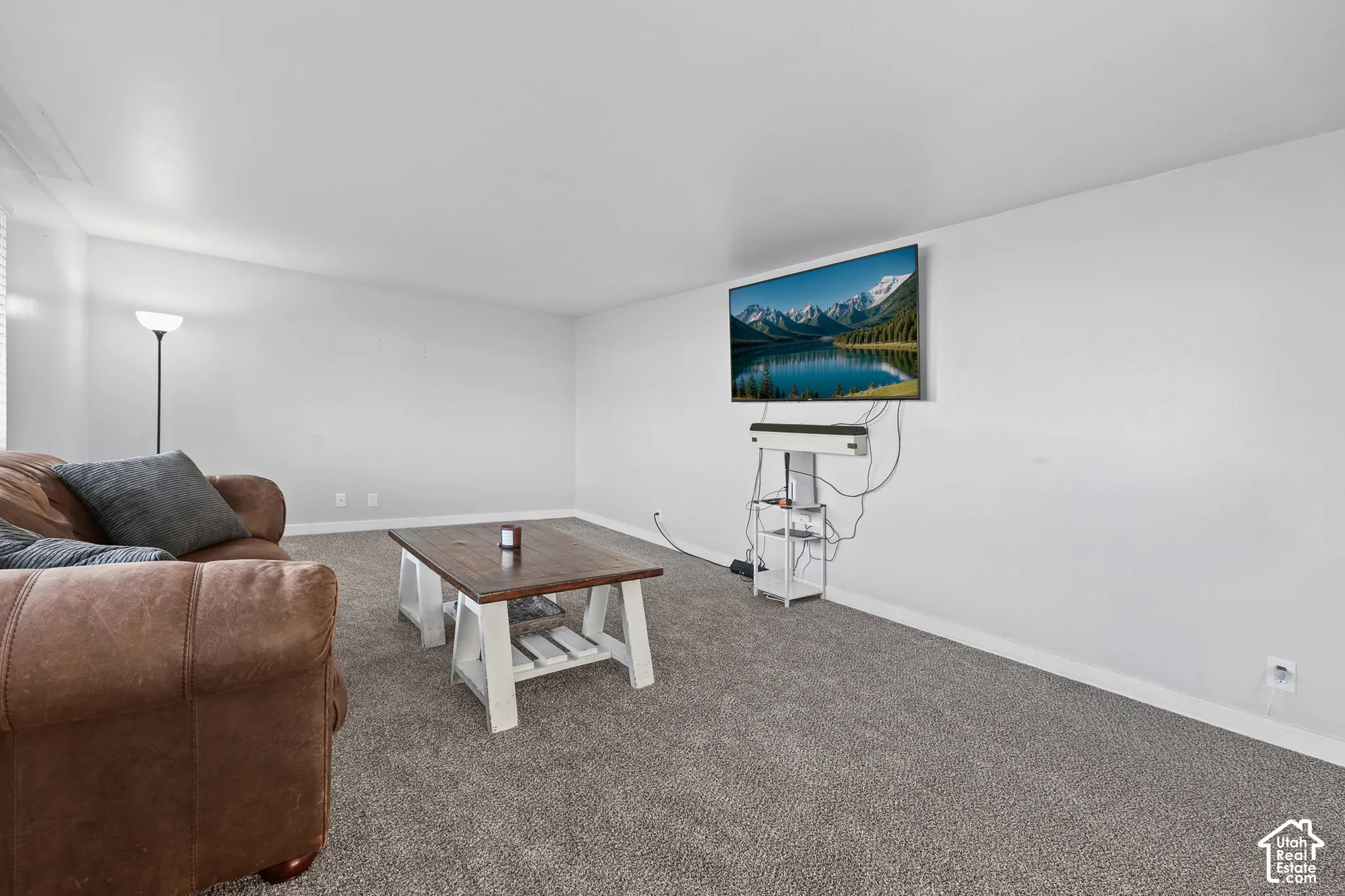 Light gray wall paint, gray carpeting, and white trim
