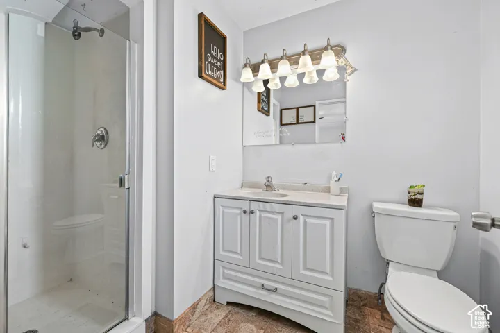 Glass-enclosed shower with chrome fixtures