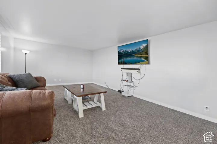 Light gray wall paint, gray carpeting, and white trim