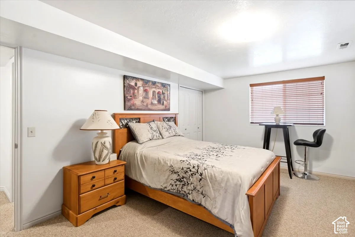 Carpeted flooring throughout, recessed lighting, and a window with blinds