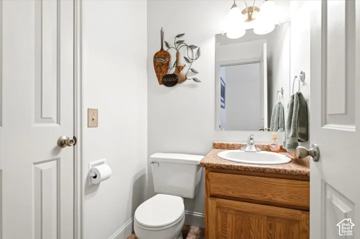 Vanity with a wood-finish cabinet, a drop-in sink, and a speckled countertop