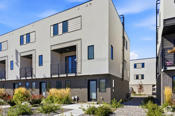 Modern exterior with contrasting stucco and brick finishes