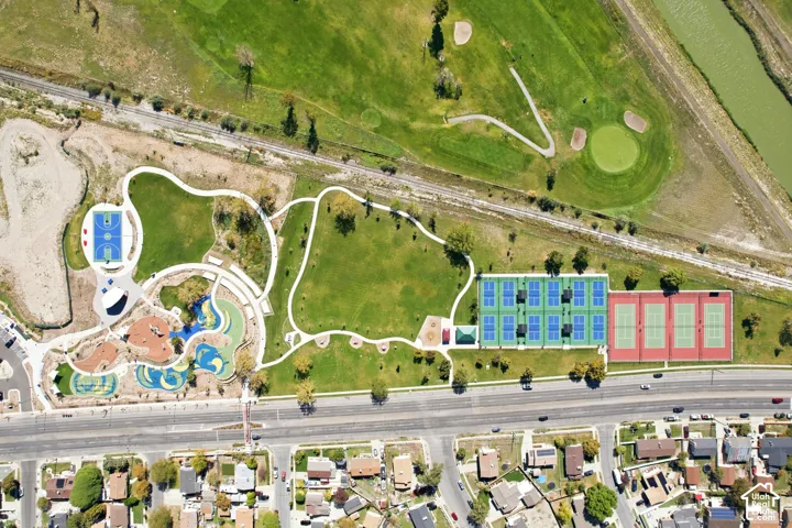 Community park featuring multiple sports courts, a large aquatic area, and extensive green spaces