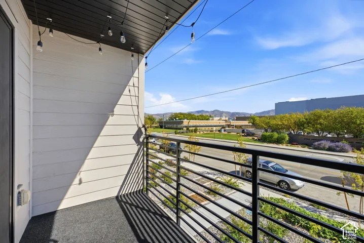 Balcony with black metal railings and a dark, textured floor