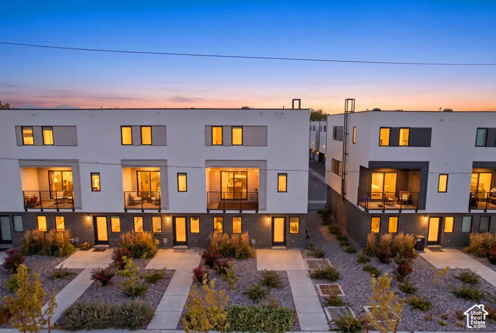 Modern townhome exteriors featuring white stucco and dark brick accents