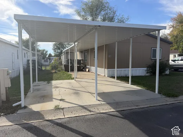 Carport with a solid roof structure and multiple support columns