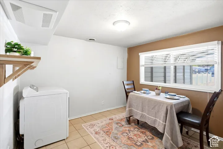 Tile flooring, wood-finish shelving, and a dual-pane window with horizontal blinds
