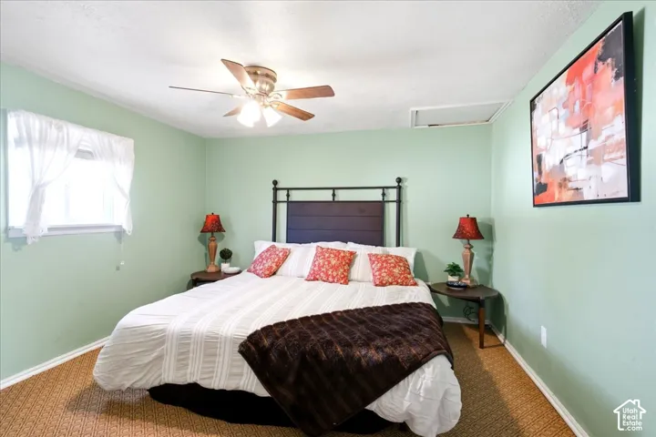 Recessed window, ceiling fan with integrated lighting, textured ceiling, light green wall finish, wood-finish flooring