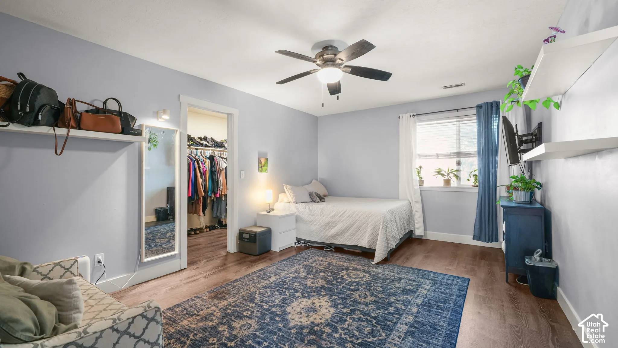 Wood-finish flooring throughout, complemented by a ceiling fan with integrated lighting