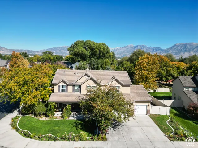 Two-story residence with a light-toned stucco exterior and a tiled roof