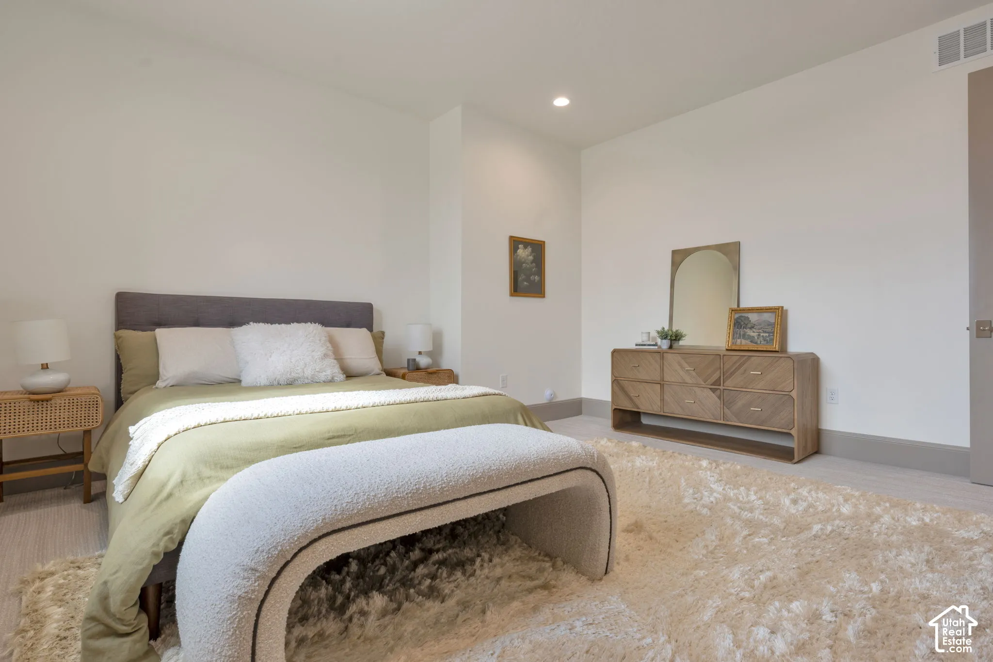 Recessed lighting, light wood-finish flooring, and crisp white walls