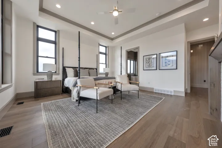Recessed lighting, wood-finish flooring, ceiling fan, coffered ceiling, and trim detailing