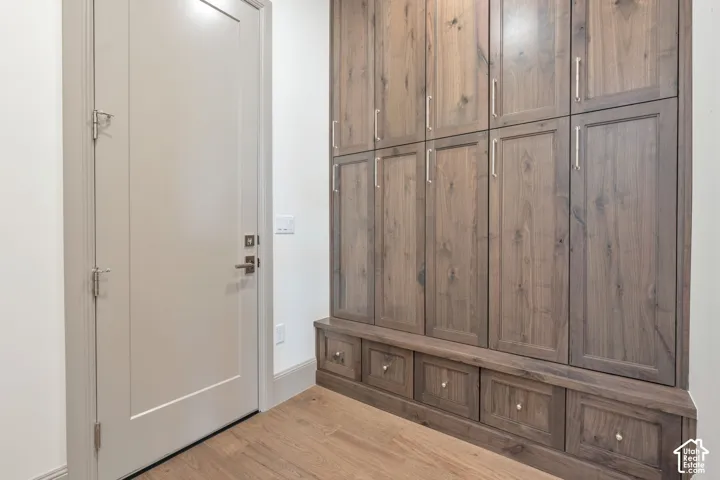 Built-in cabinetry with wood-finish doors and drawers, featuring brushed nickel hardware