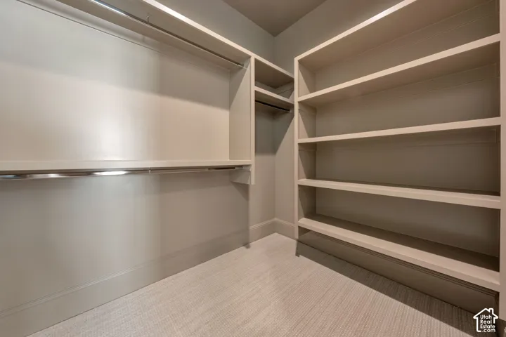 Built-in shelving, hanging rods, and light-toned wall finishes
