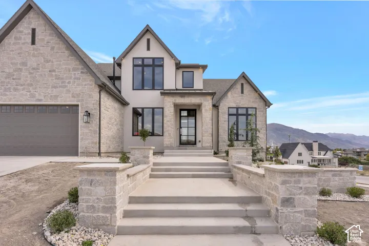 Stone and stucco exterior with prominent gables