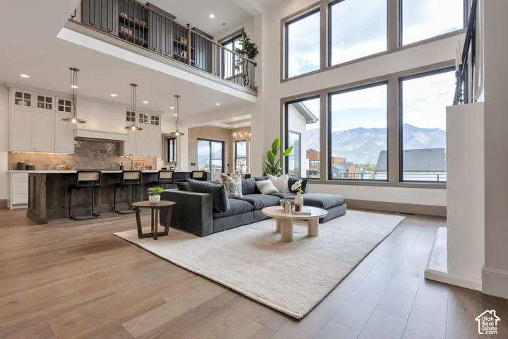 Open-concept living space with high ceilings and wood-finish flooring
