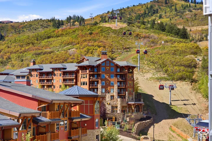 Multi-story building featuring natural wood siding and stone accents