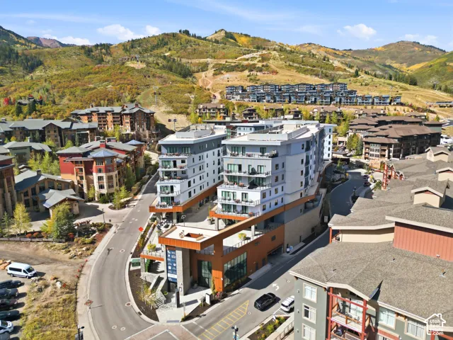Modern multi-story building featuring expansive balconies and a flat roof design