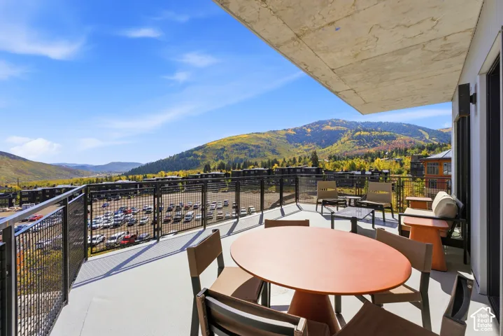 Expansive exterior balcony with metal railings and a concrete ceiling