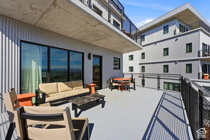 Expansive outdoor deck with a concrete ceiling and a light-colored surface