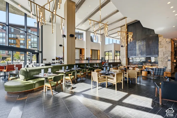 Soaring double-height ceiling with exposed beam structure and skylights flooding the space with natural light