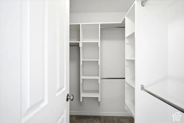 Master Bedroom custom closet organization system featuring white shelving and chrome hanging rods