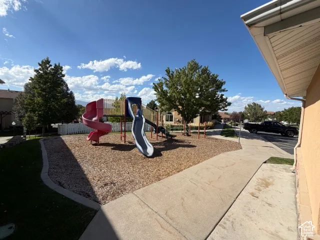 On-site playground with a spiral slide and traditional slide, bordered by wood chips