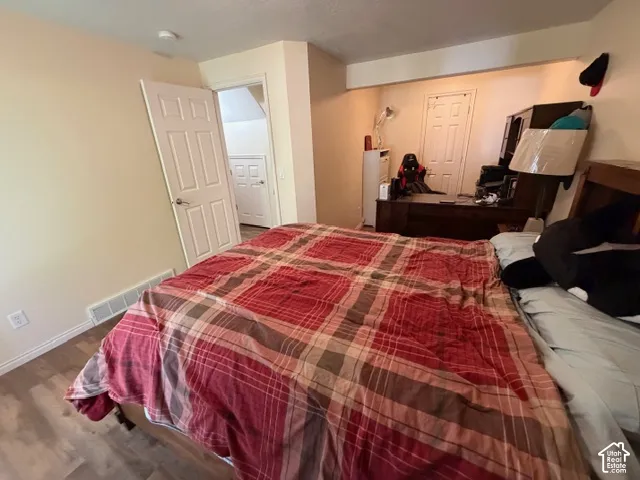 Wood-finish flooring, light-toned walls, and white trim