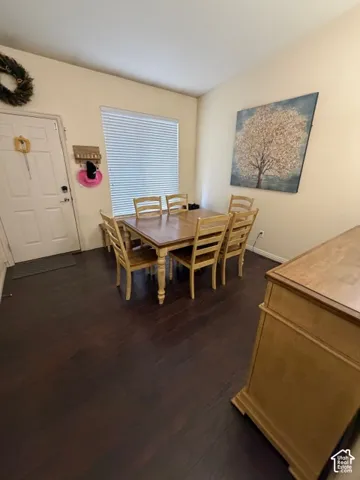 Recessed ceiling, wood-finish flooring, and a large window with blinds