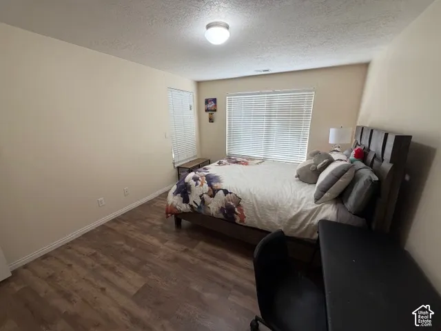 Wood-finish flooring, neutral wall tones, and overhead flush-mount lighting