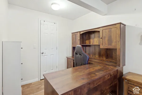 Room featuring wood-finish flooring and a flush-mount ceiling light fixture