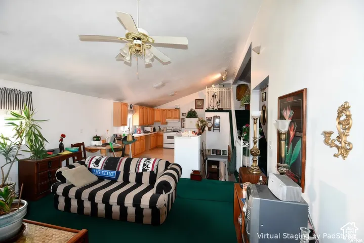 Vaulted ceilings, a ceiling fan with light fixture, light wood-finish cabinetry, and white appliances