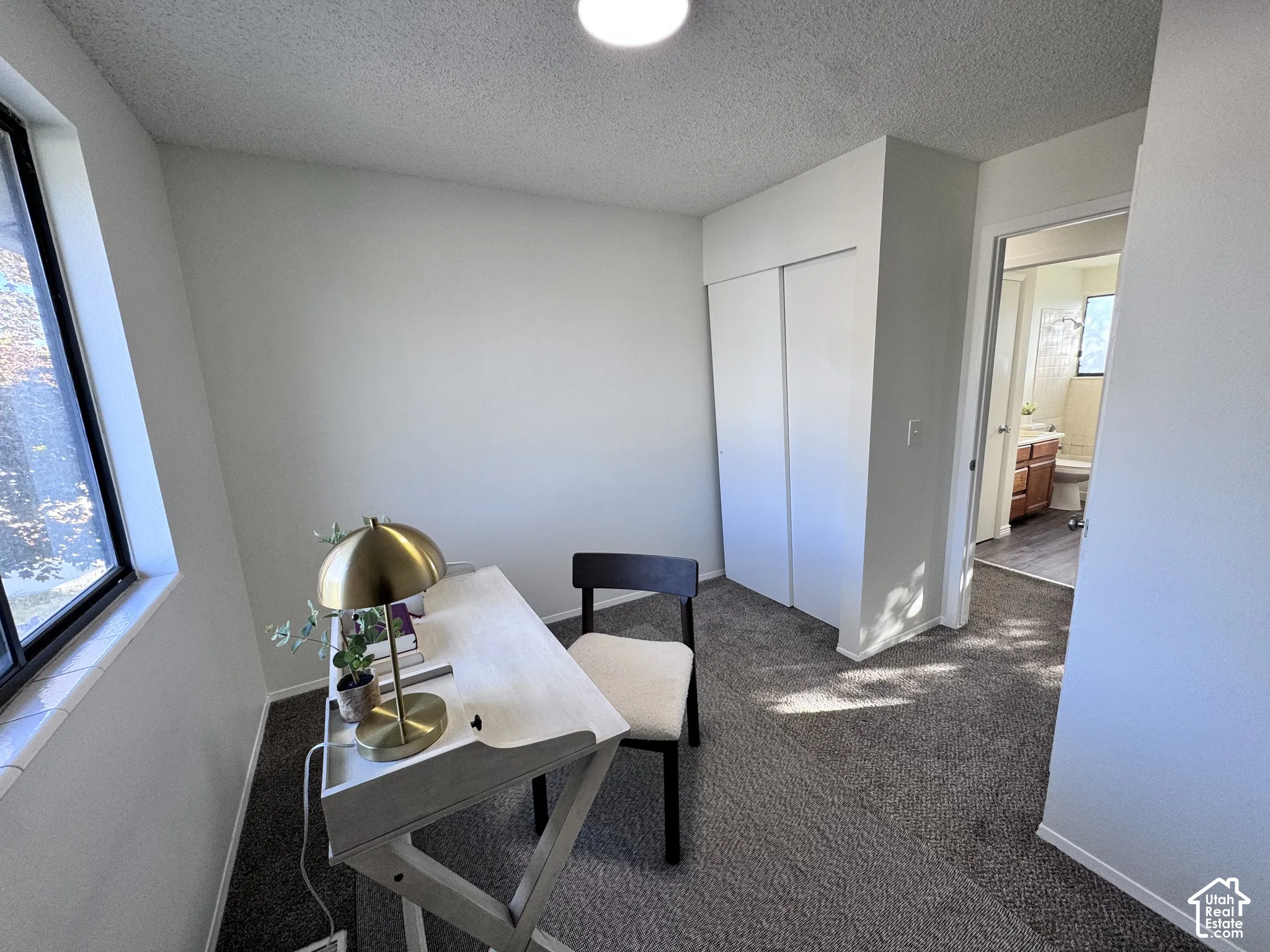 Window with white trim, a recessed light fixture, and a sliding door closet