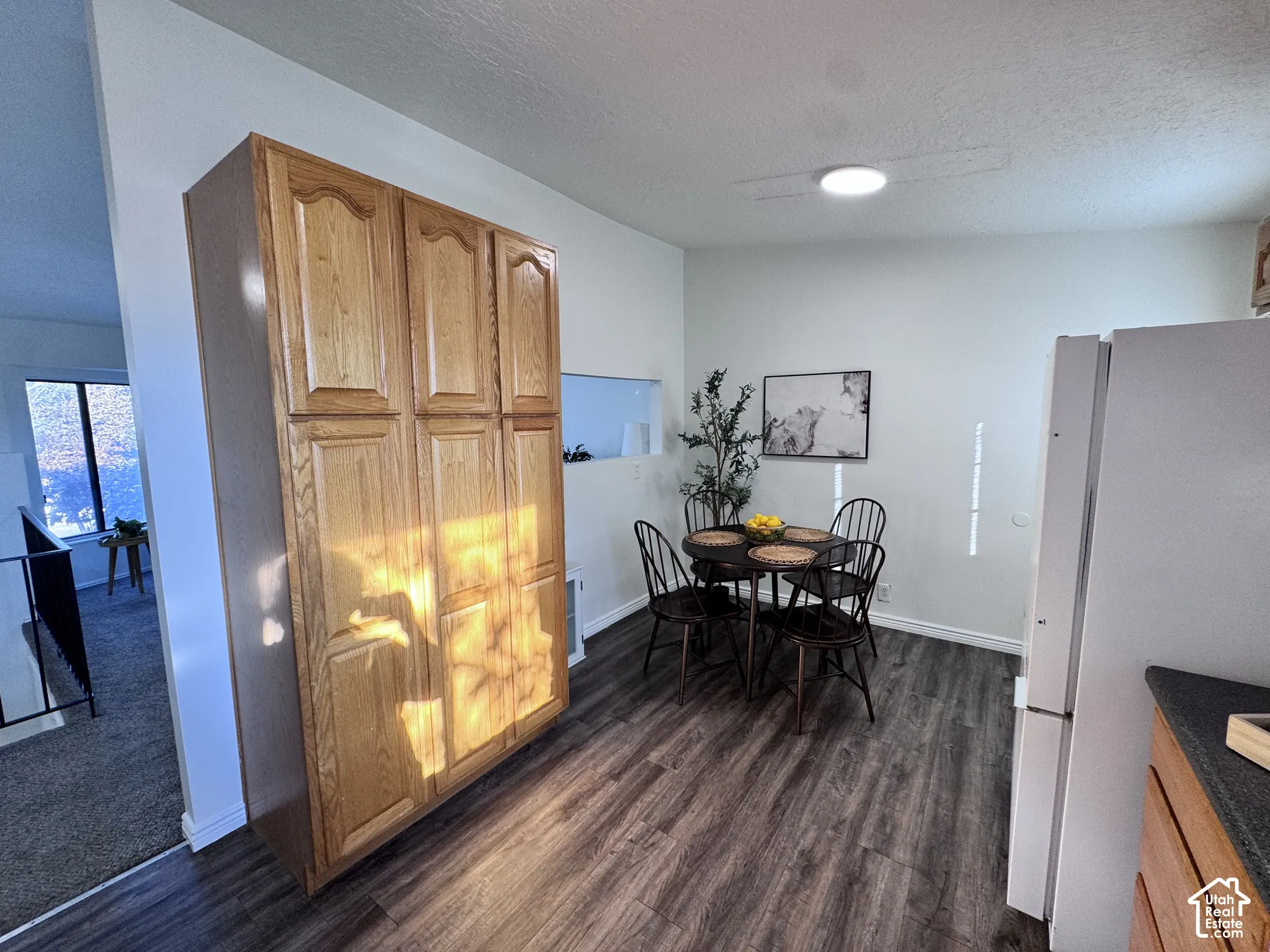 Wood-finish flooring throughout, complemented by a built-in pantry with wood cabinetry