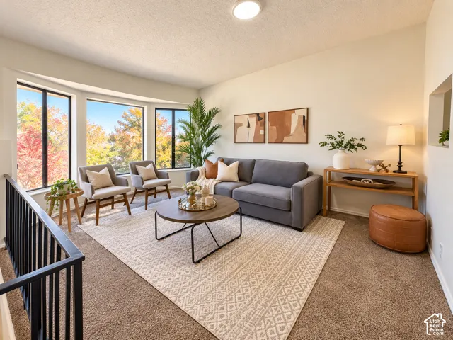 Bay window with multiple large panes, sloped ceiling, recessed lighting, and carpet flooring